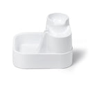 Eine seitlich angewinkelte Ansicht des leeren weißen Haustier-Wasserbrunnens mit drei verschiedenen Ebenen, aus denen Haustiere wählen können zu trinken, vor weißem Hintergrund.